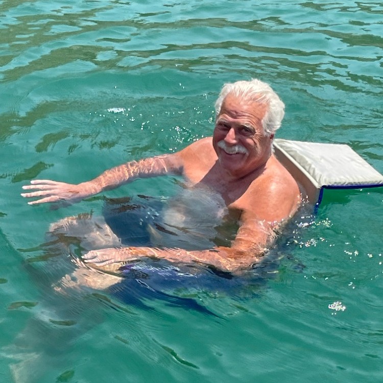 floating chair on river with man smiling