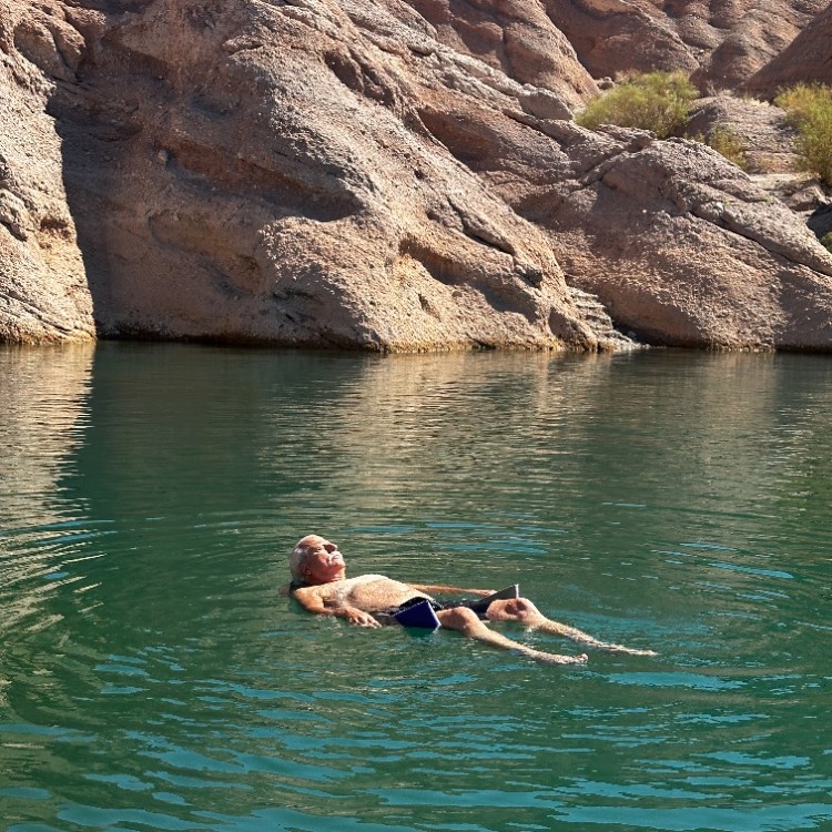 floating chair on river with man laying down